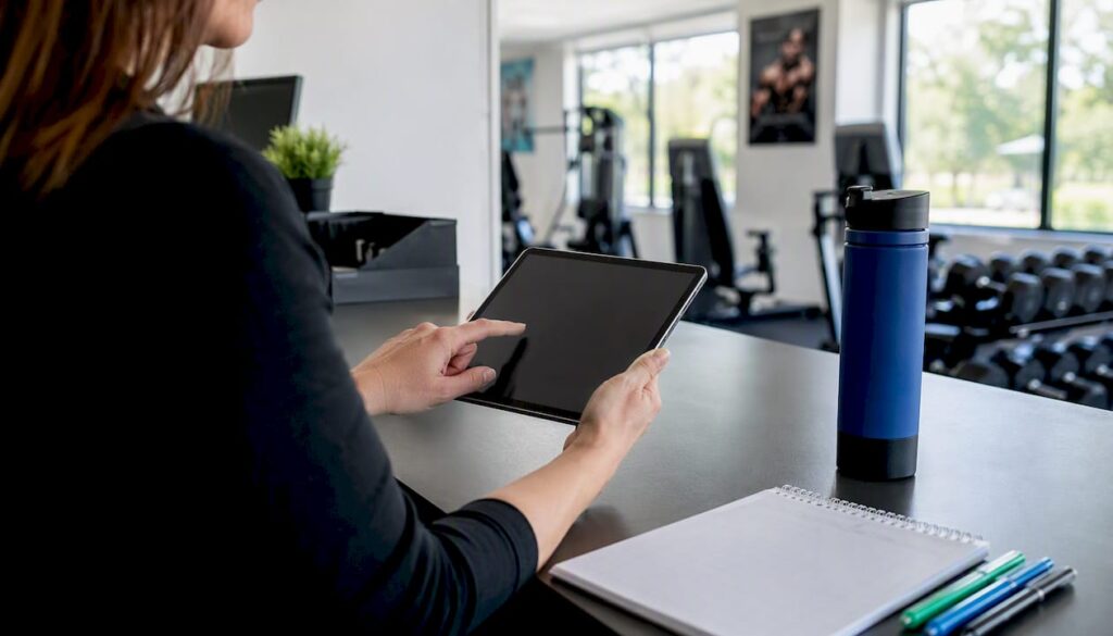 Hands writing staff contact and qualification info