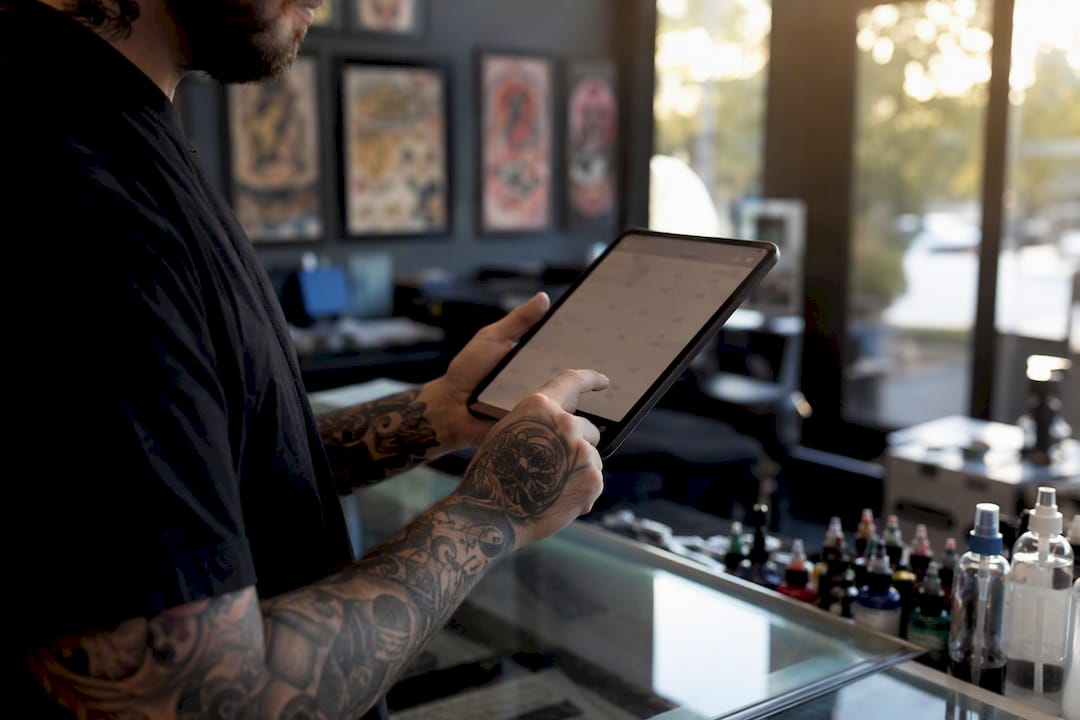 Tattoo artist adjusting appointment calendar