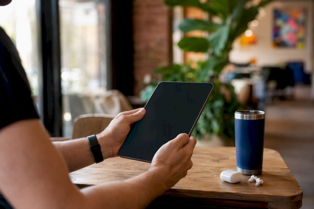 Hands holding smartphone with screen off