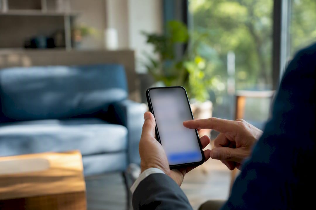 Hand managing deposits on smartphone